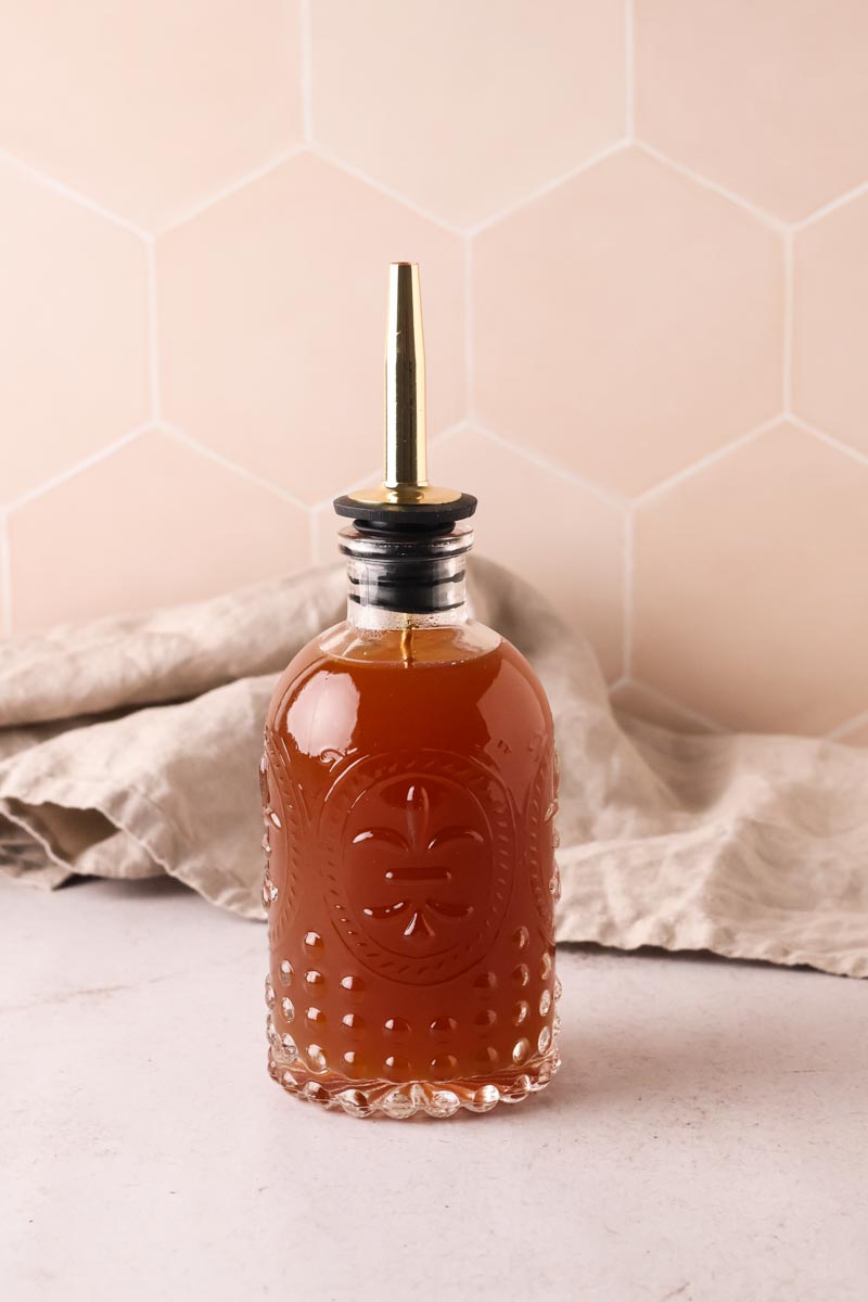 apple cinnamon simple syrup in a glass bottle