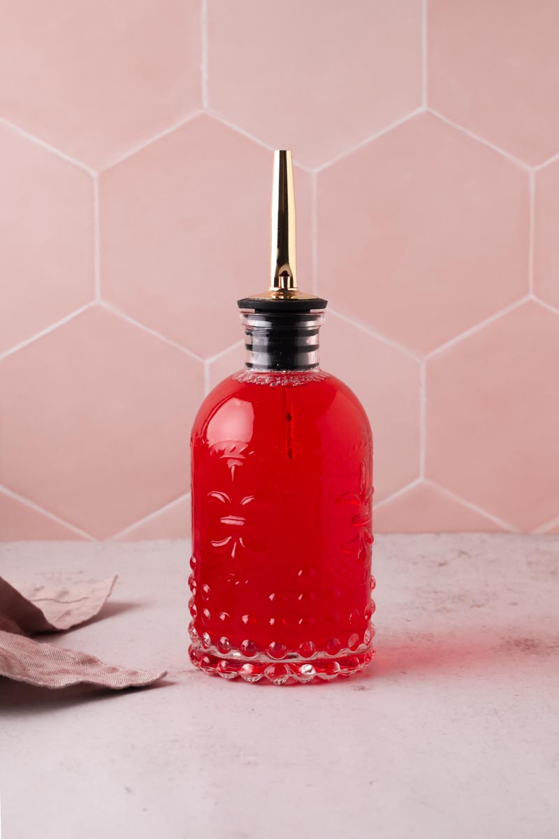 strawberry simple syrup in glass bottle