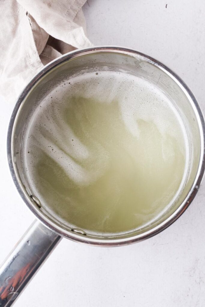 blended honeydew melon syrup in a saucepan