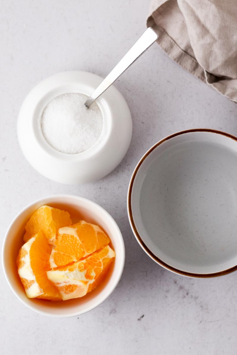orange slices, water and sugar on table