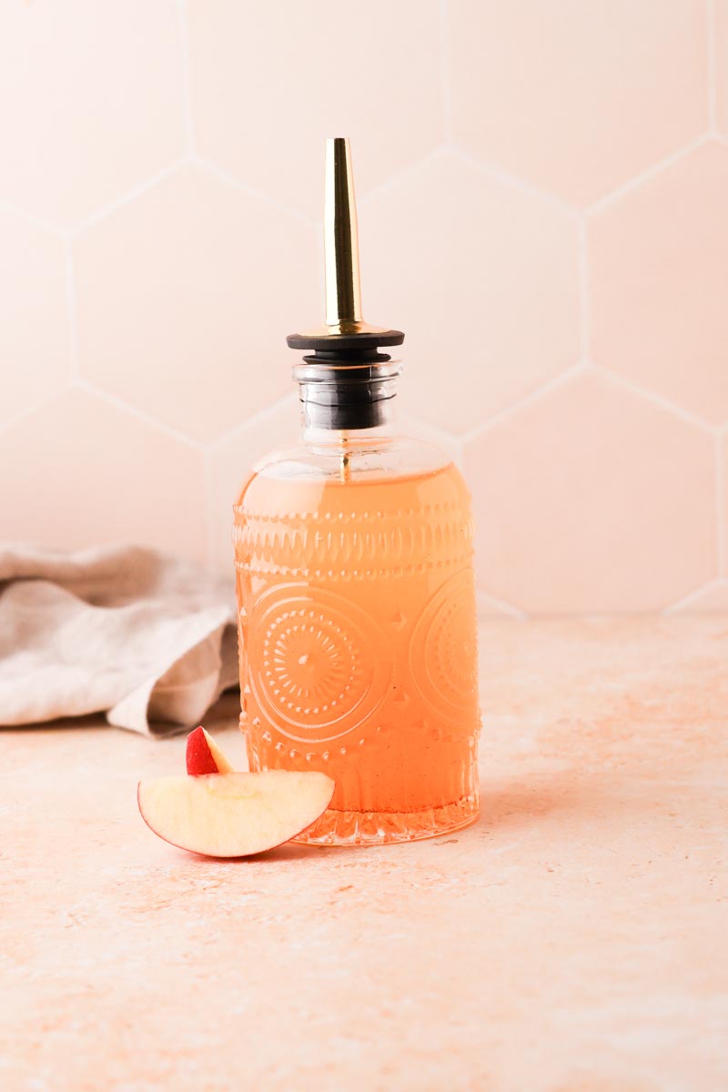 apple simple syrup in glass bottle