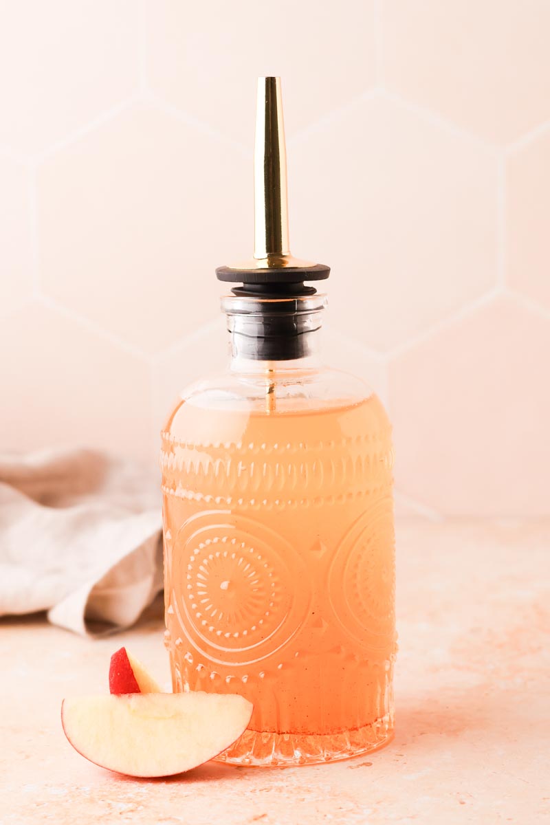 close up of apple simple syrup in bottle