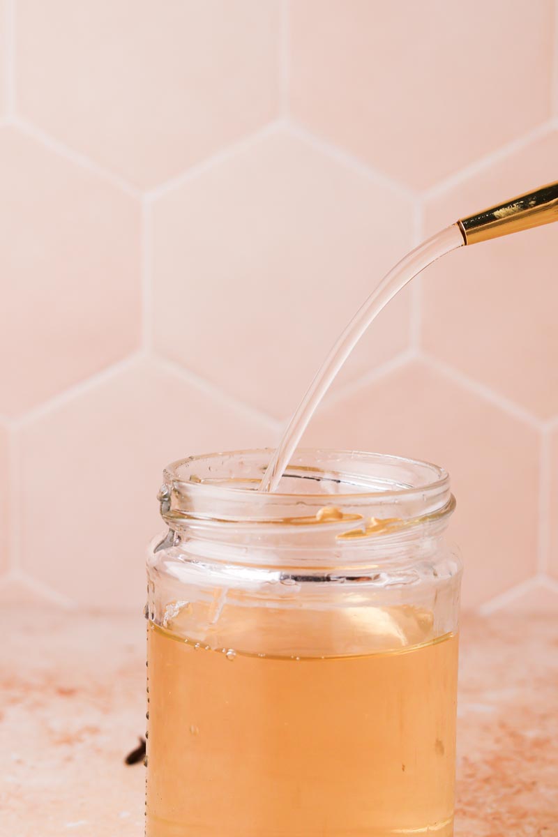 a pour shot of clove simple syrup