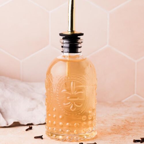 freshly made clove simple syrup in a bottle