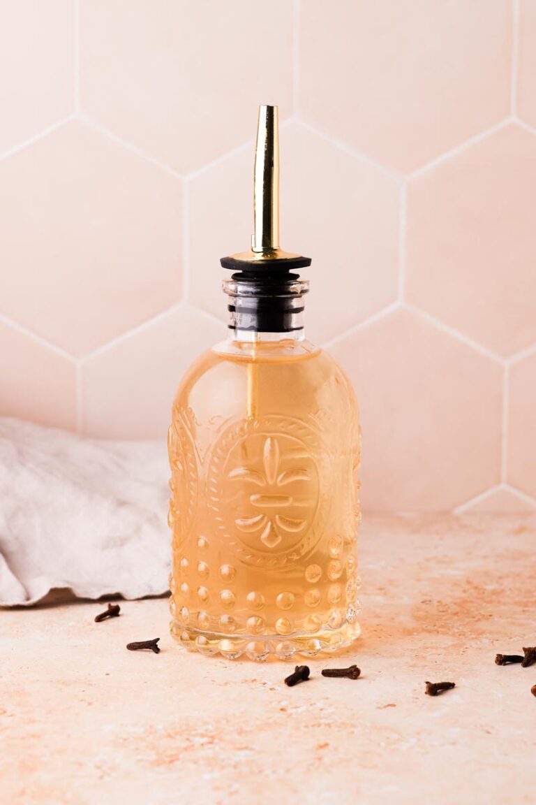 freshly made clove simple syrup in a bottle