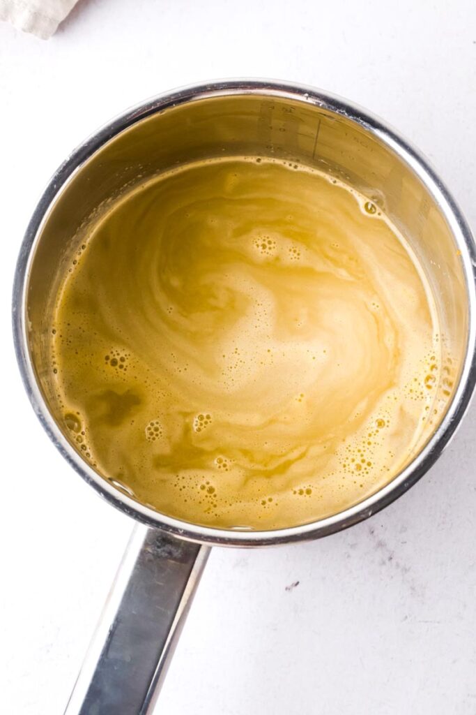 orange simple syrup in saucepan