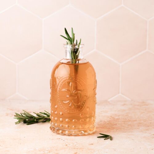 rosemary simple syrup in syrup bottle