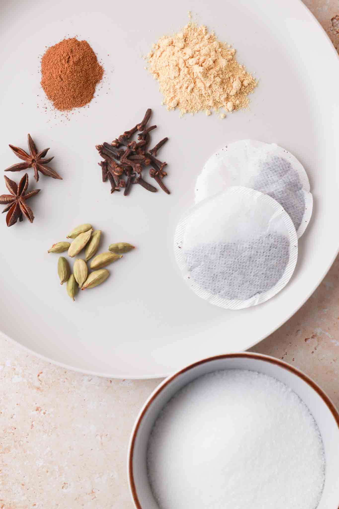 ingredients for chai simple syrup on a plate