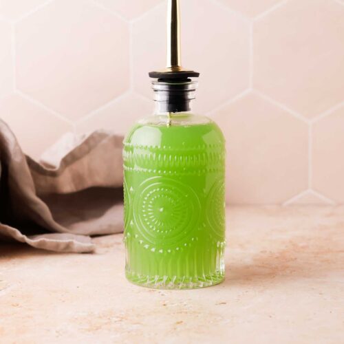 cucumber simple syrup in glass bottle