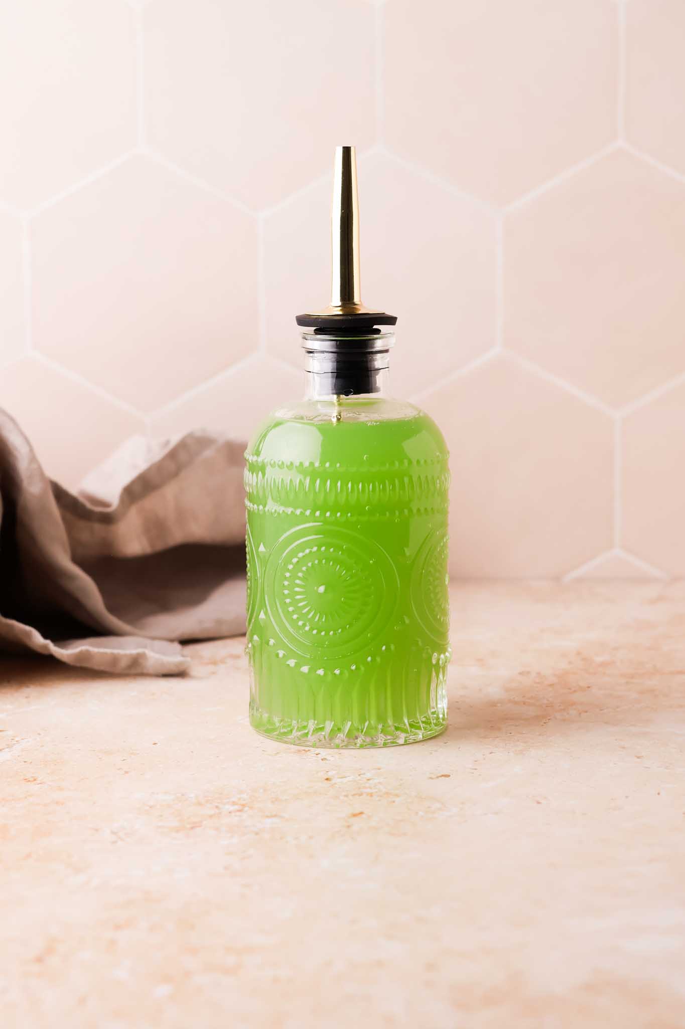 cucumber simple syrup in glass bottle