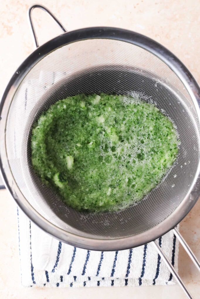 blended cucumber pulp straining in a sieve