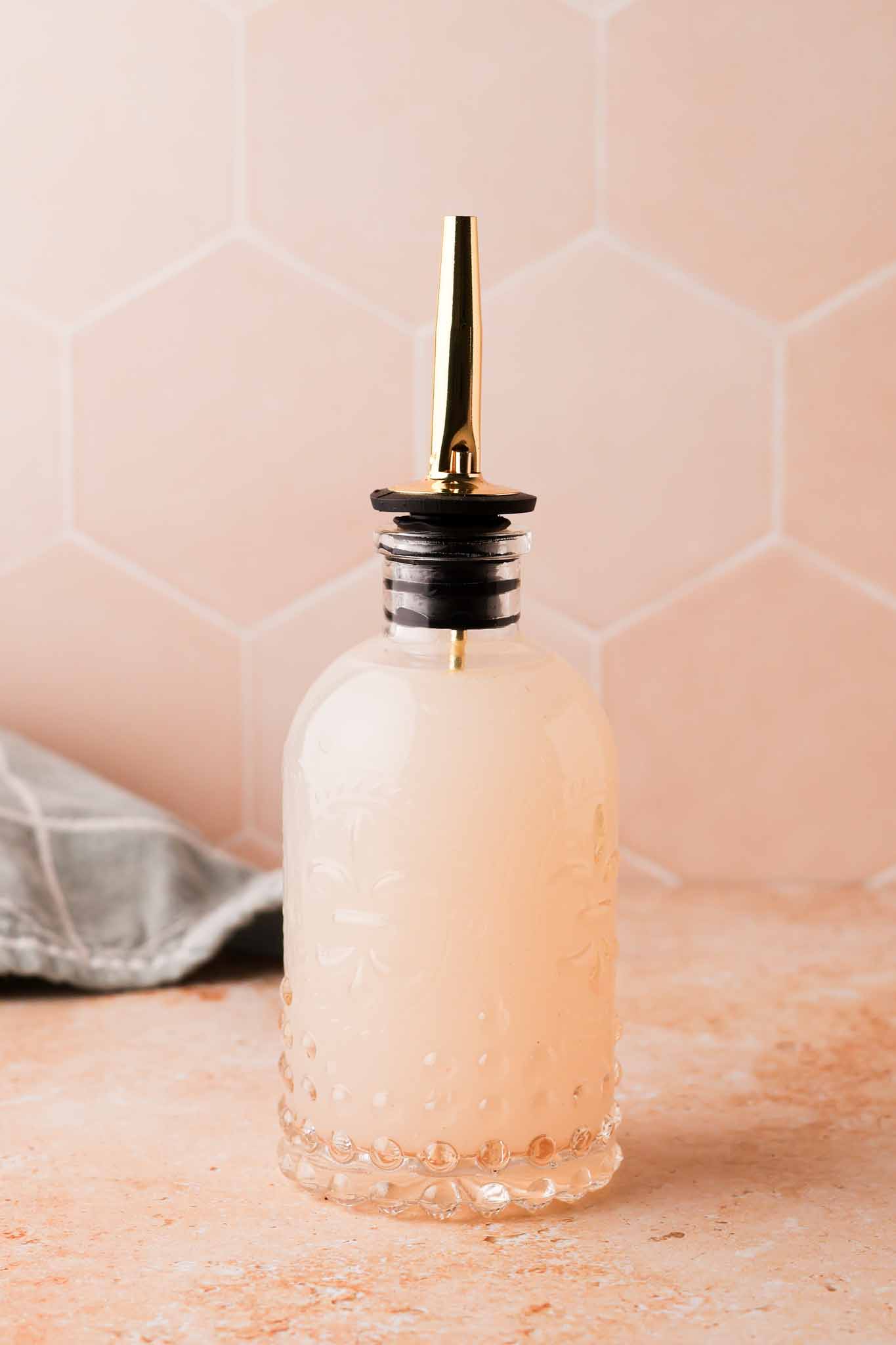 homemade lychee syrup in a glass bottle