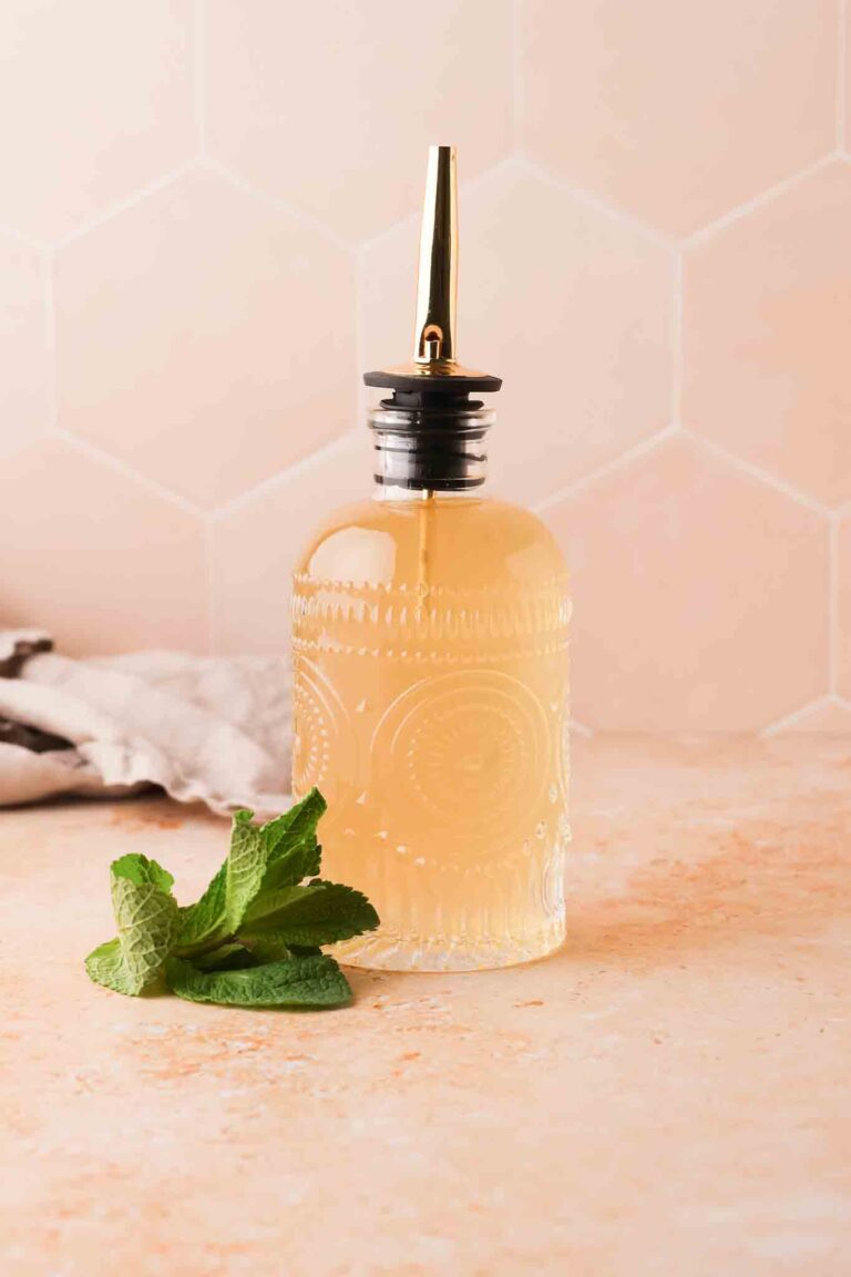 homemade mint simple syrup in a glass bottle