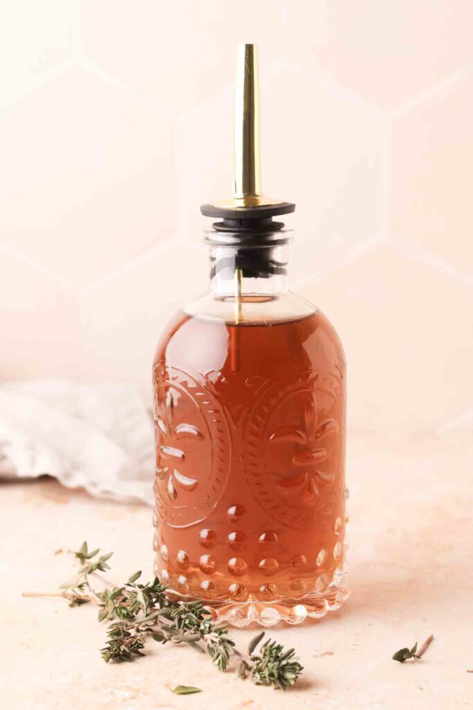 thyme simple syrup in a bottle