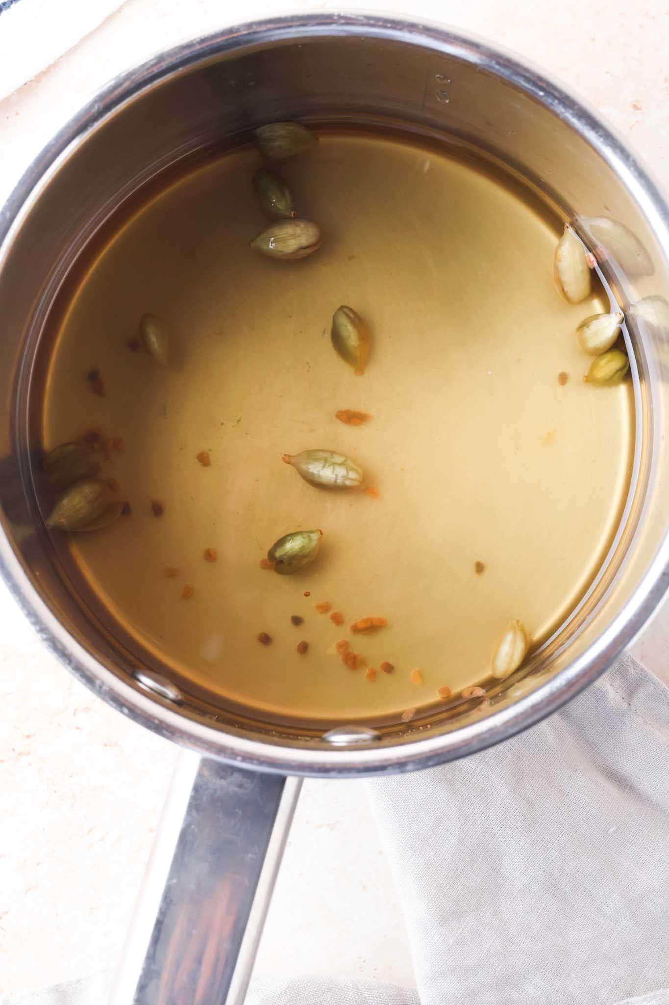 cardamom syrup simmering in a post