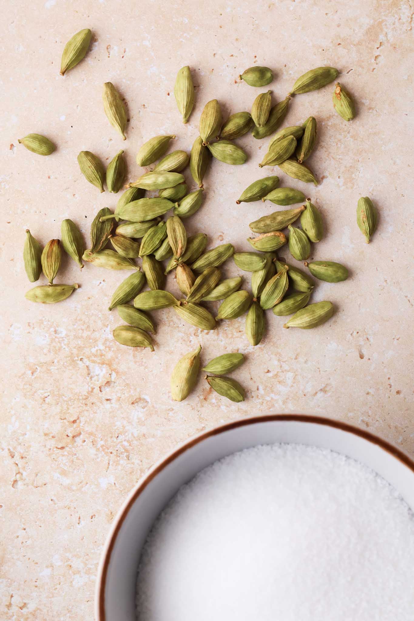 green cardamon and sugar in a small bowl