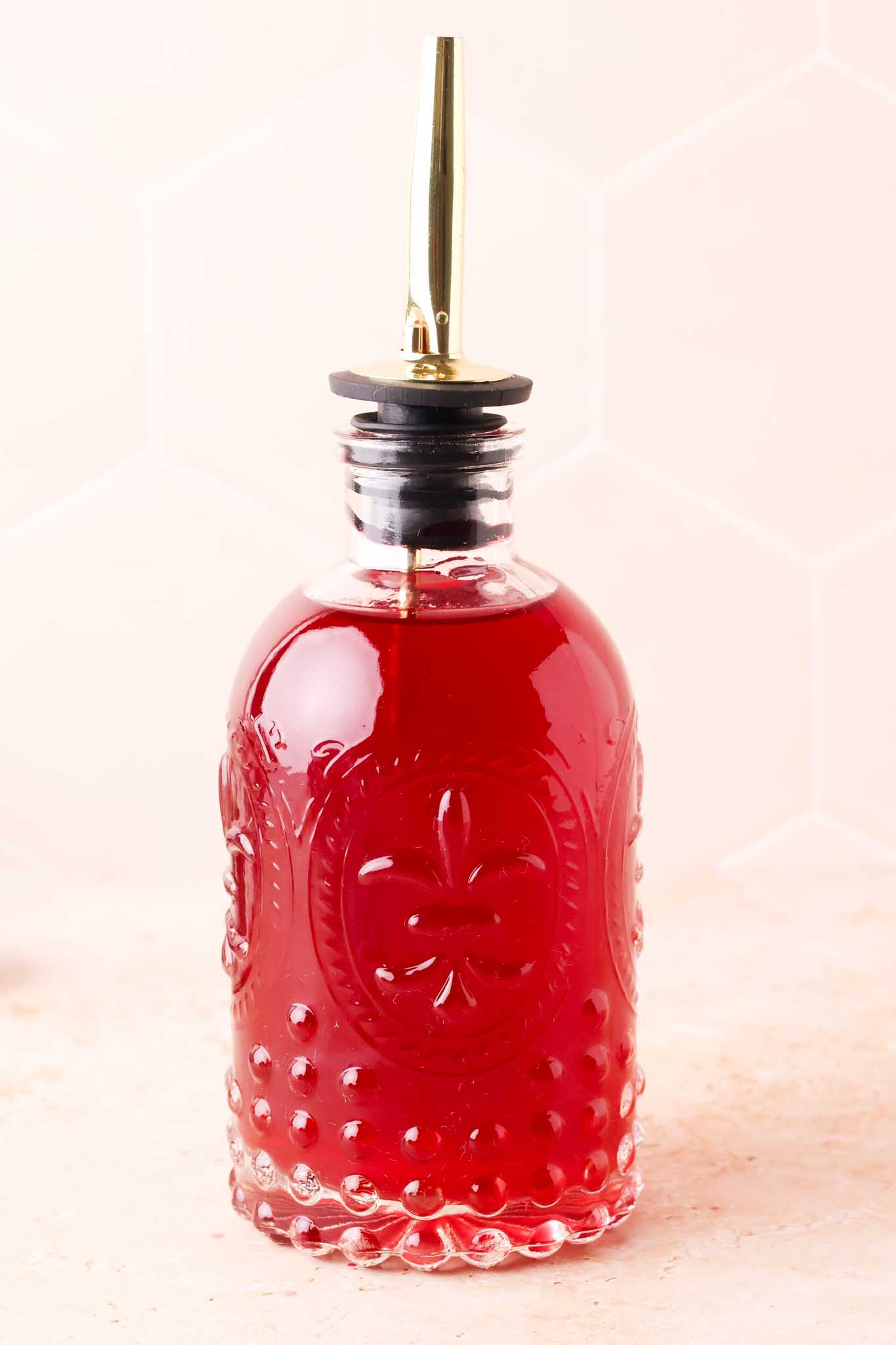 a close up of blackberry simple syrup in a bottle