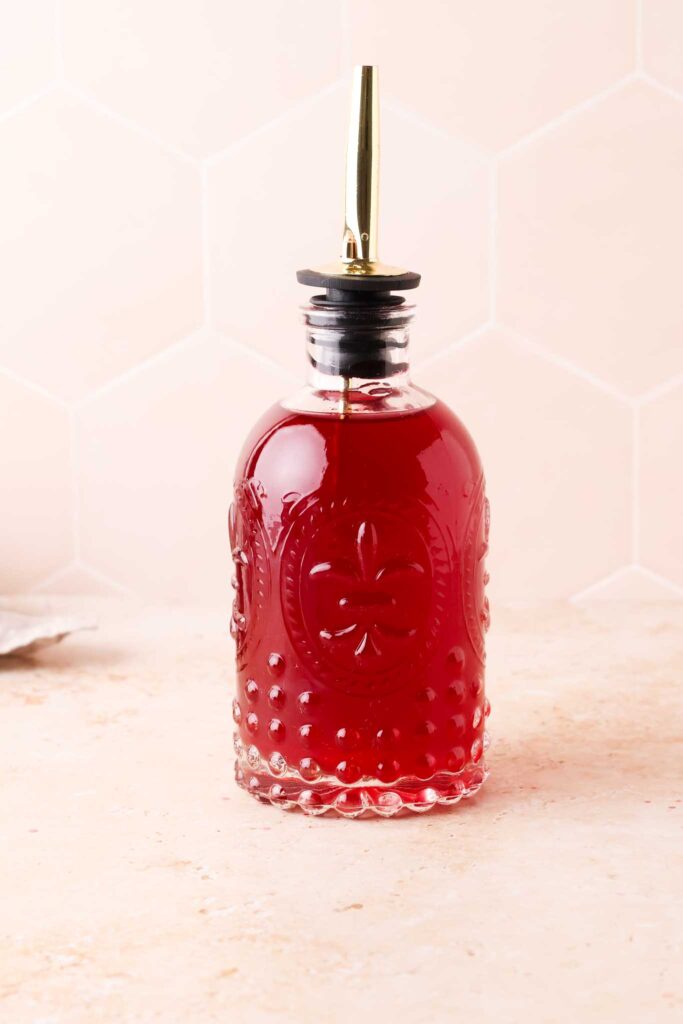 blackberry simple syrup in a glass bottle