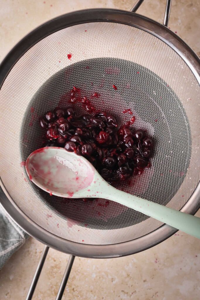 blackcurrants straining in sieve