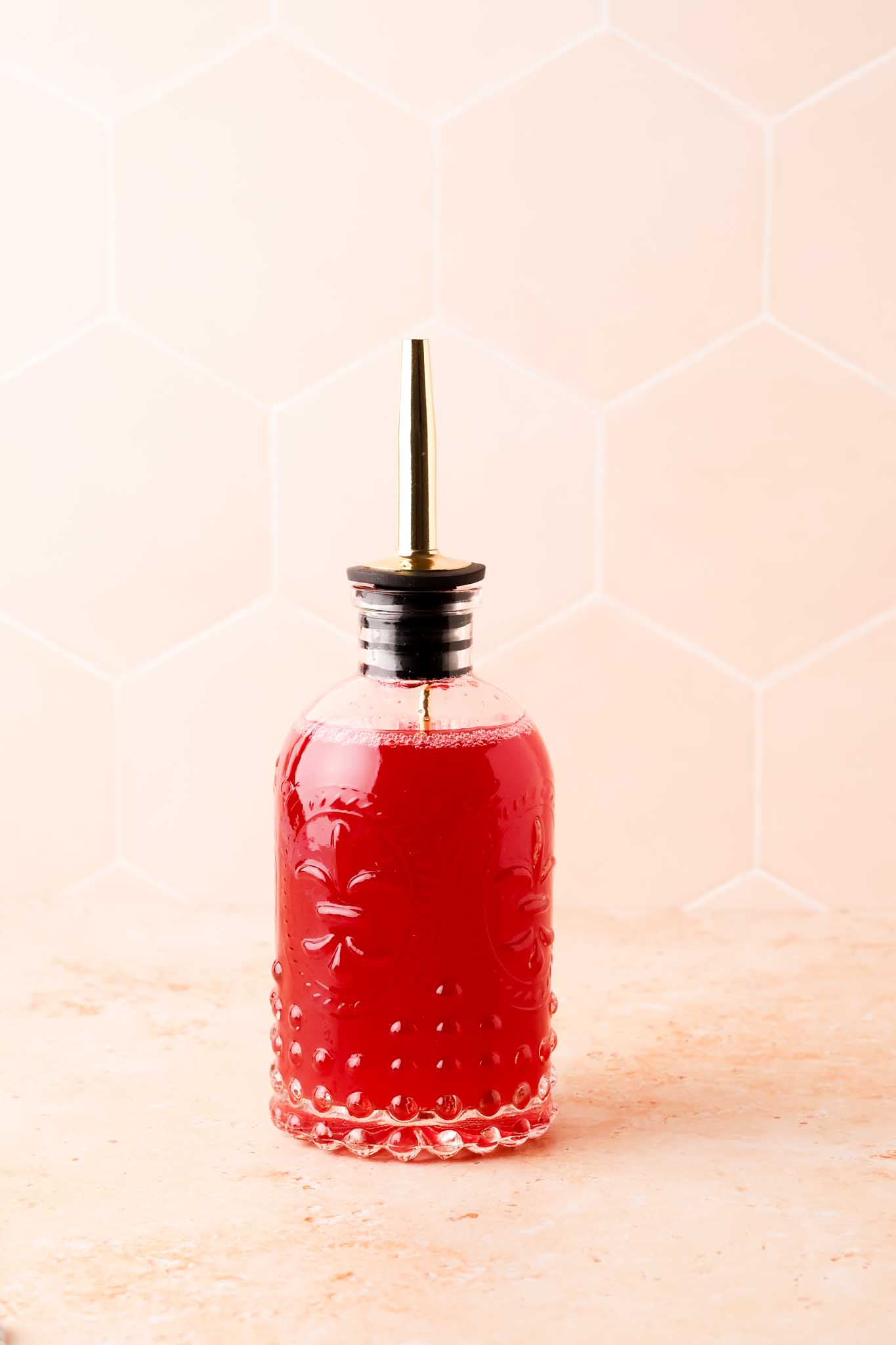 raspberry simple syrup in glass bottle