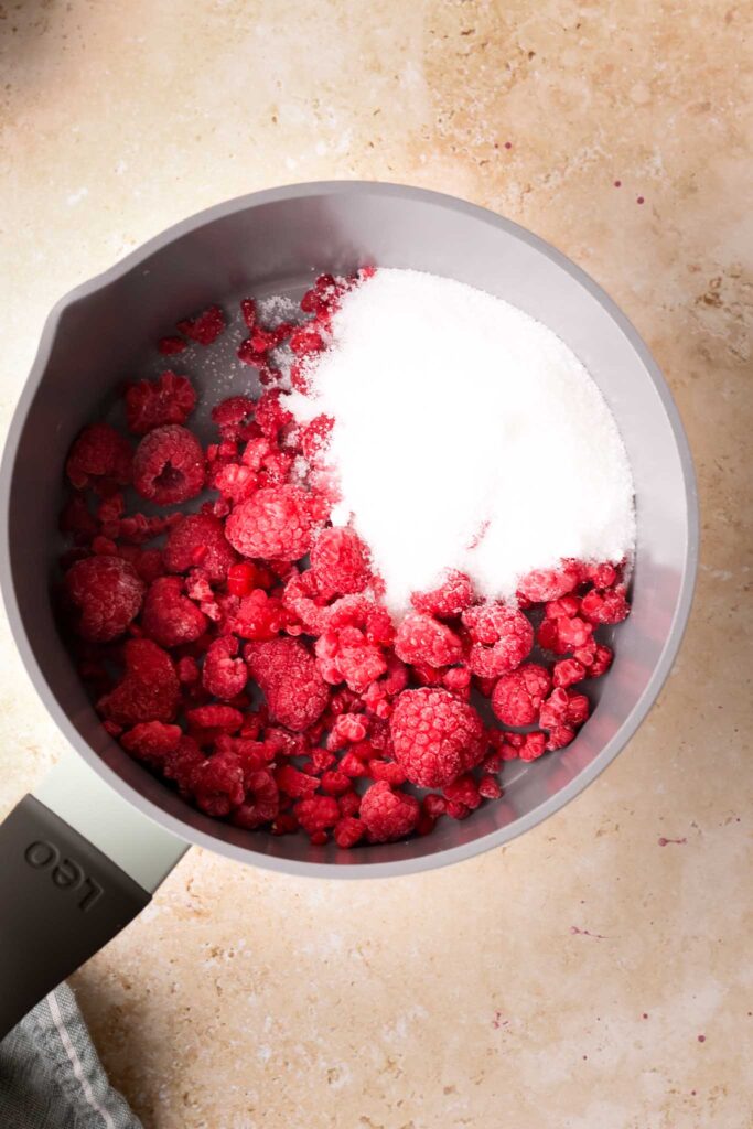 frozen raspberries and sugar in a saucepan