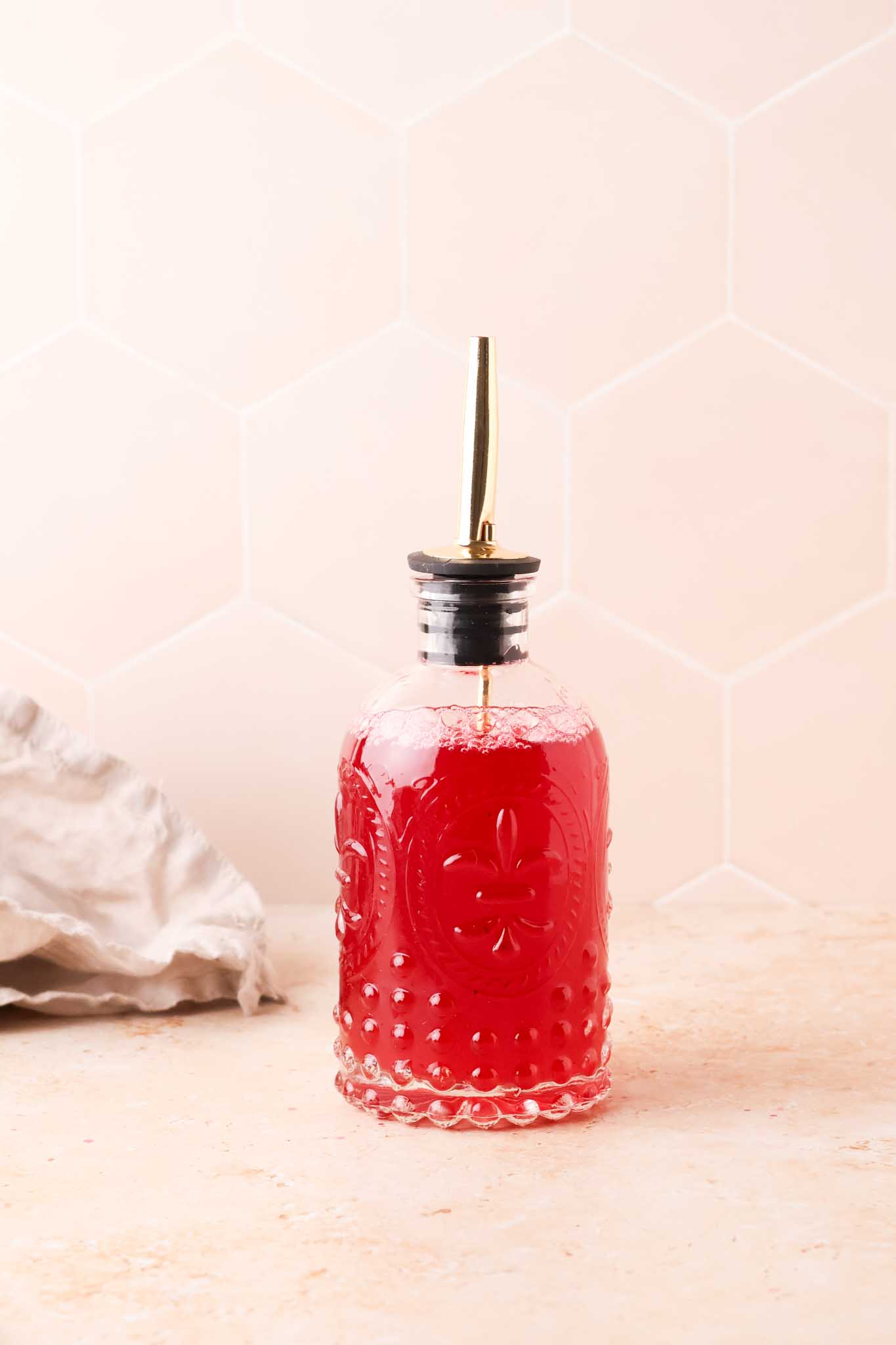 red currant syrup in a glass bottle