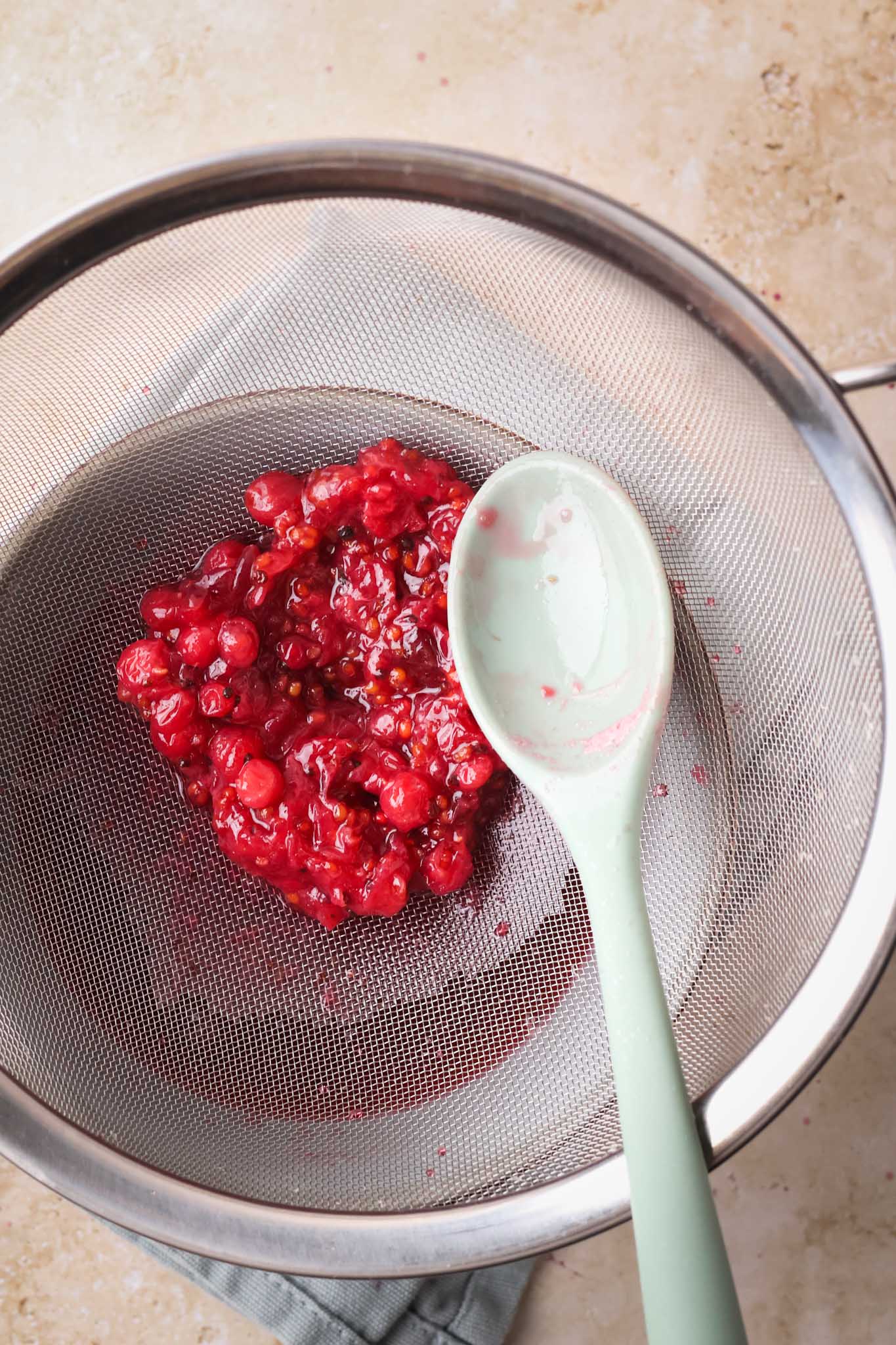 red currant bits in a seive