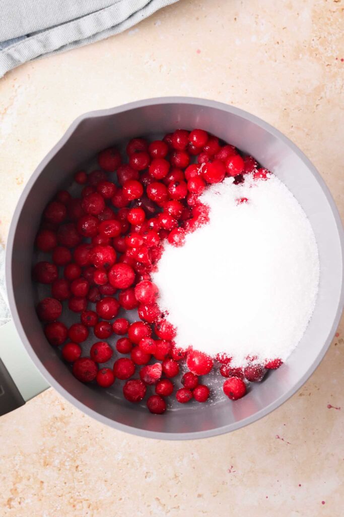 red currants and white sugar in a pan