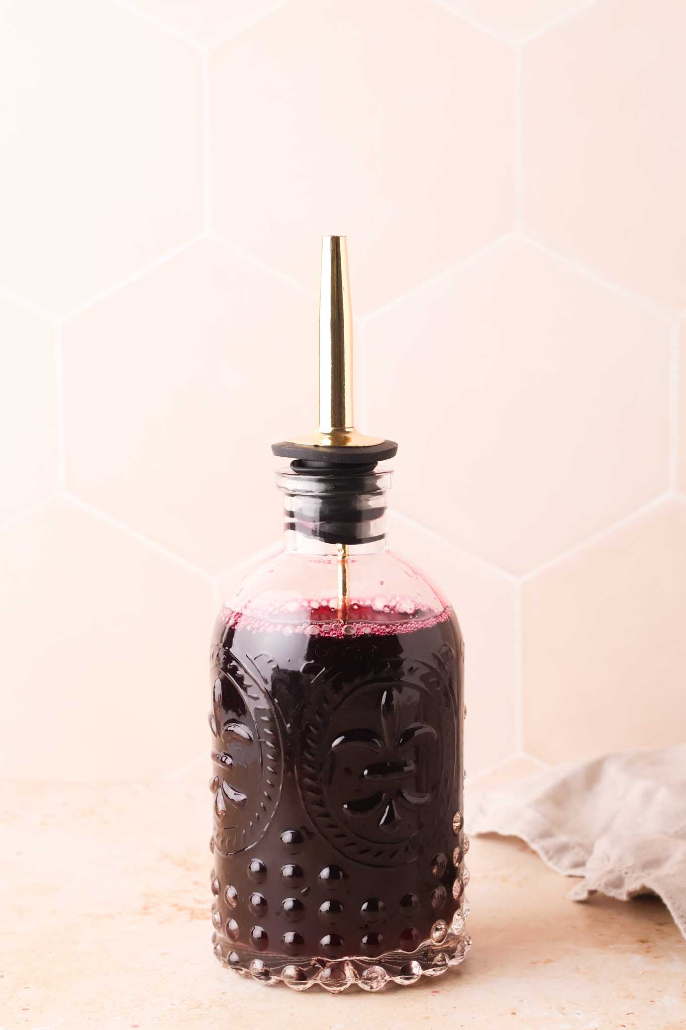 blueberry simple syrup in a glass bottle