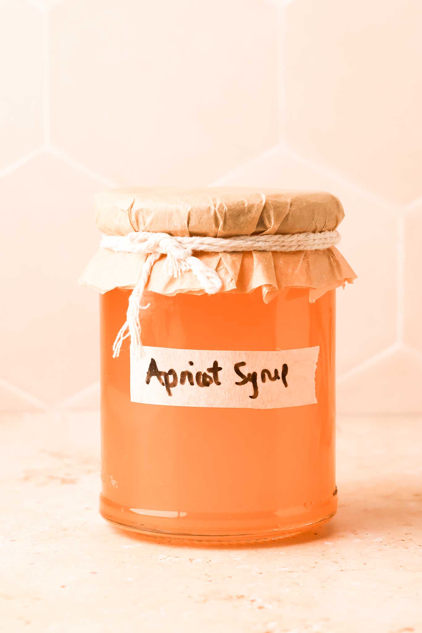 homemade apricot simple syrup in a glass jar