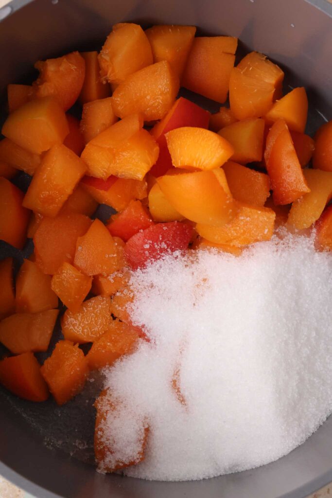 chopped apricot and white sugar in saucepan
