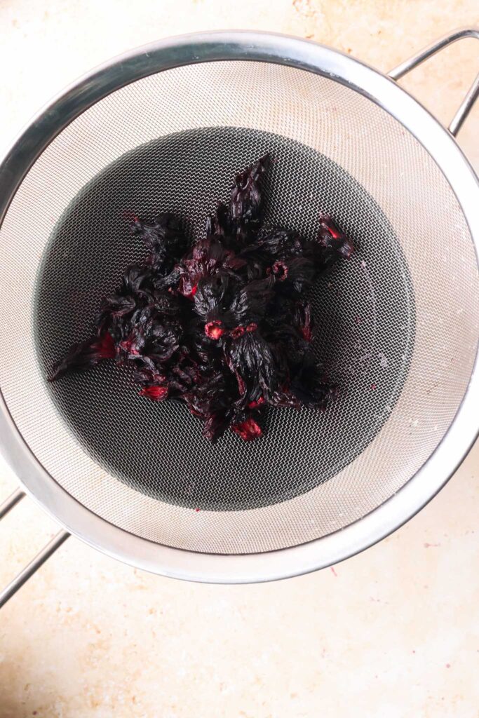 hibiscus flowers draining in sieve