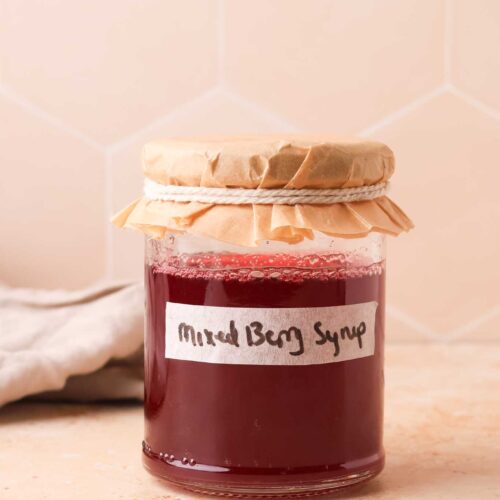 mixed berry simple syrup in glass jar