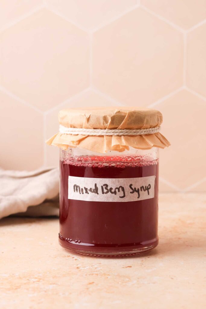 mixed berry simple syrup in glass jar