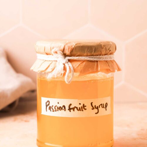 passion fruit simple syrup in a glass bottle