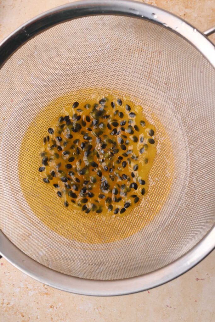 passion fruit seeds straining from syrup