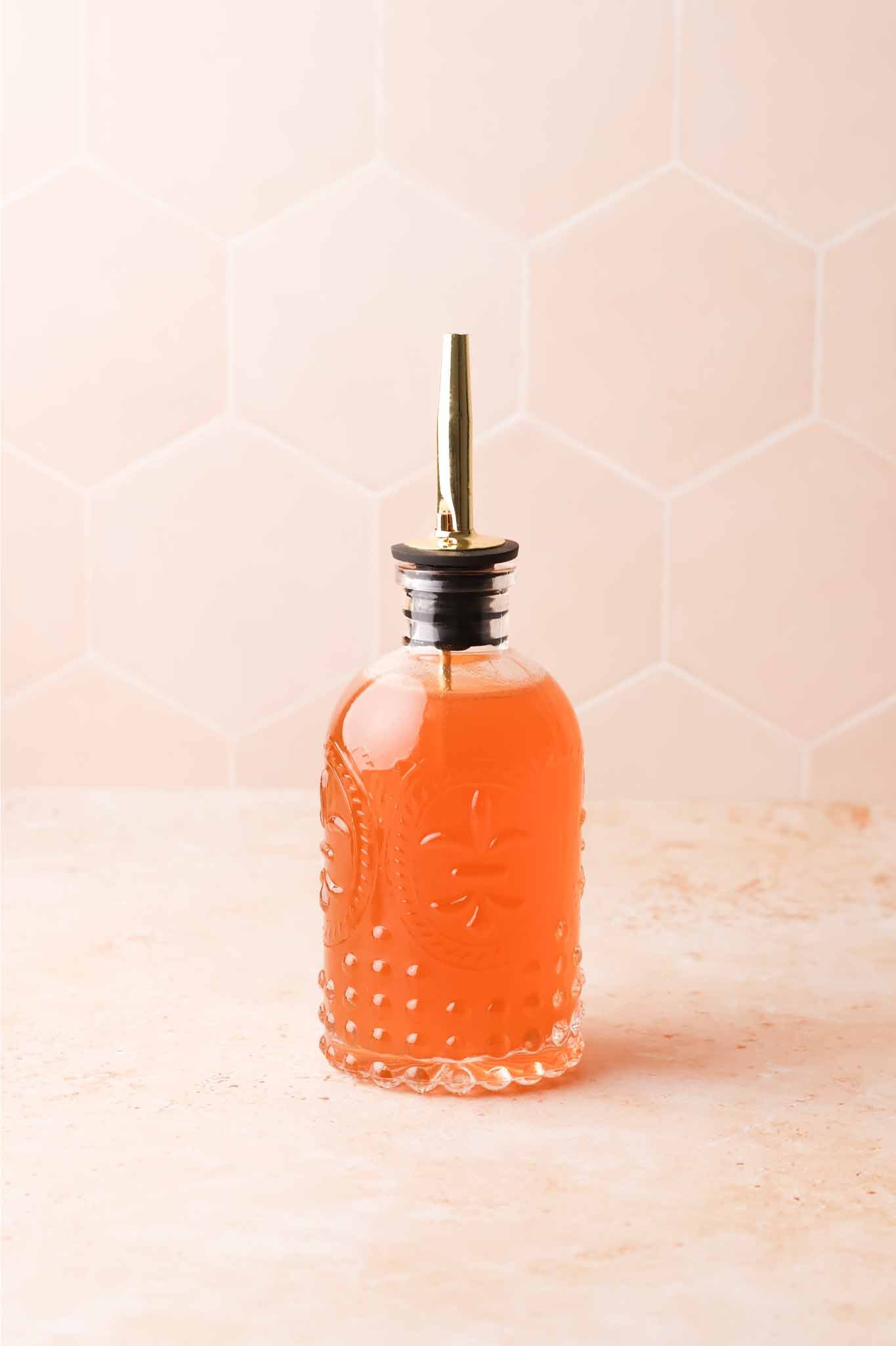 bottle of golden apple cider syrup on a table
