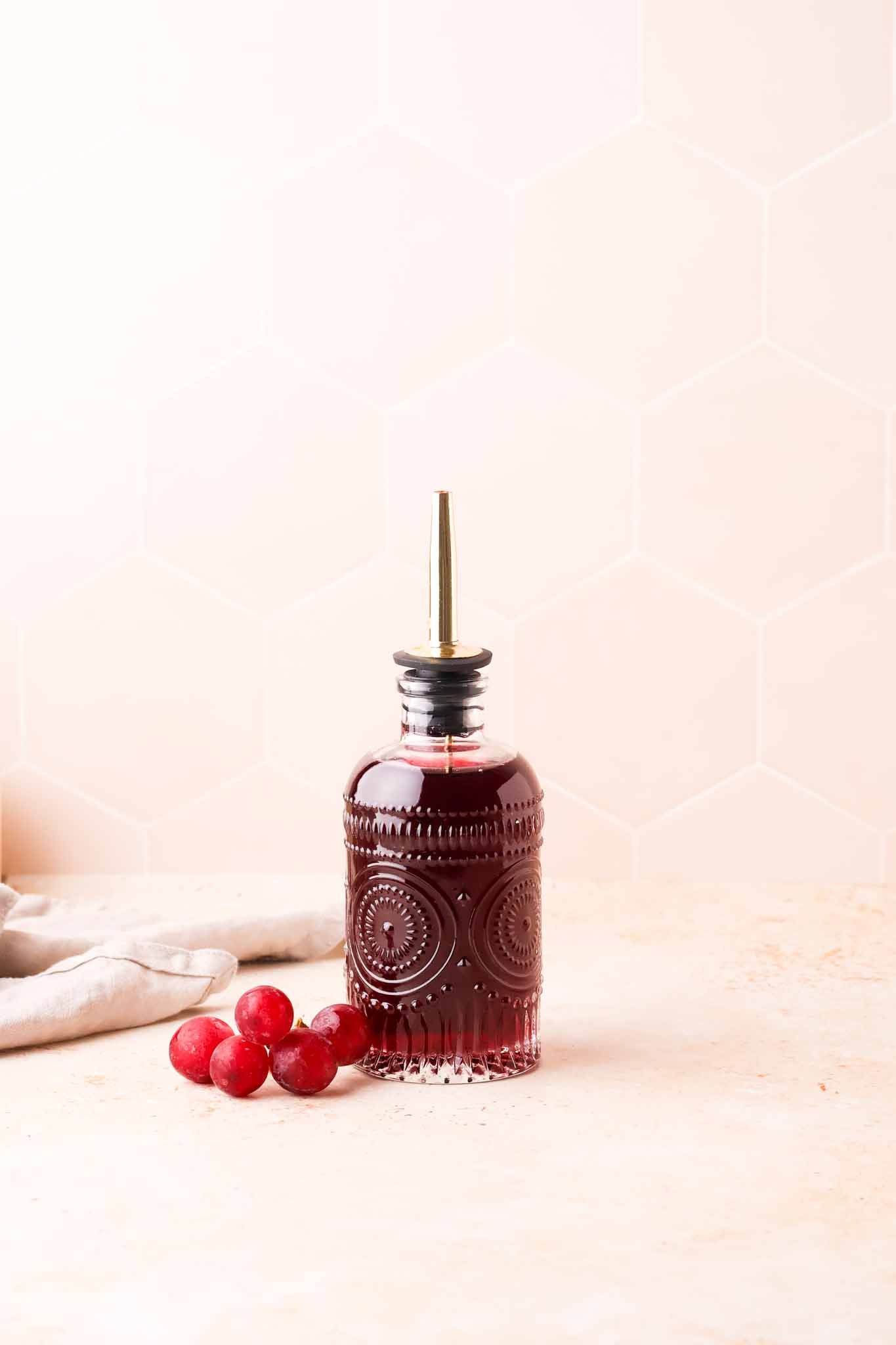 homemade grape syrup in a clear glass bottle