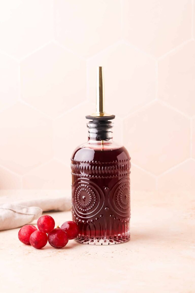 purple grape syrup stored in a glass bottle