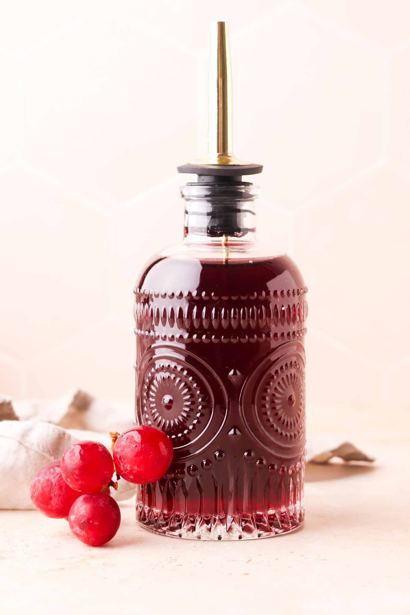 glass bottle filled with homemade grape syrup