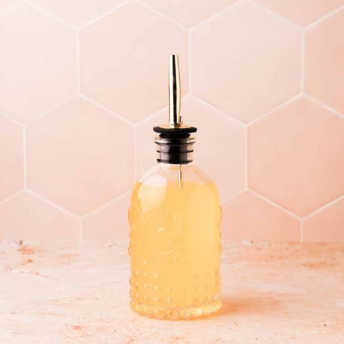 a small batch of orange blossom simple syrup in a glass dispenser bottle