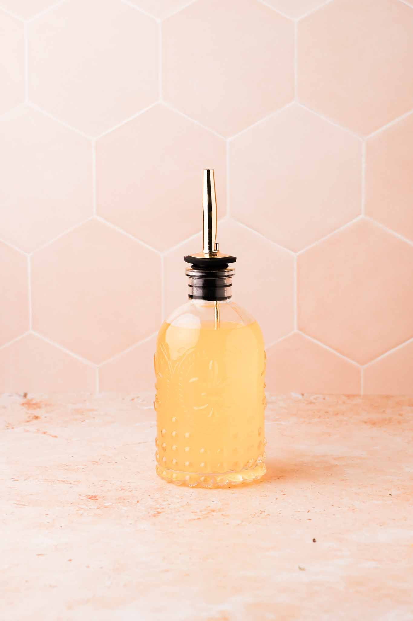 a small batch of orange blossom simple syrup in a glass dispenser bottle